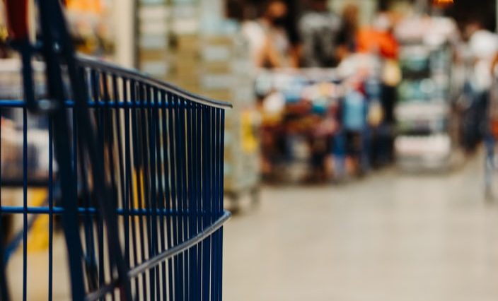 blue shopping cart on street during daytime